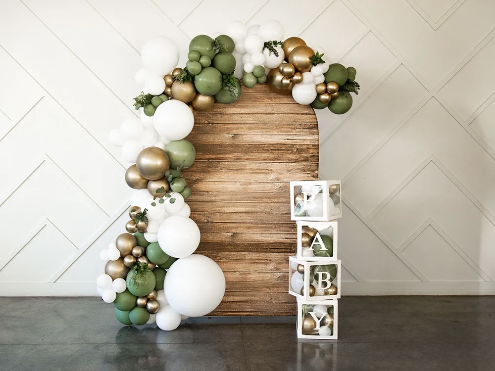 White, sage green, and gold organic balloon garland with BABY letter blocks